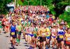 Race-Specific Marathon Training: Your Final 12 Weeks to Success With Coach T Large group of marathon runners racing together with strong energy and momentum.