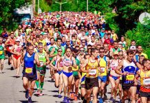 Race-Specific Marathon Training: Your Final 12 Weeks to Success With Coach T Large group of marathon runners racing together with strong energy and momentum.
