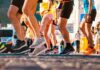 Start Running Safely: Coach T’s Powerful Beginner Method Close-up view of multiple runners beginning a race, showing only their legs and athletic running shoes in motion.