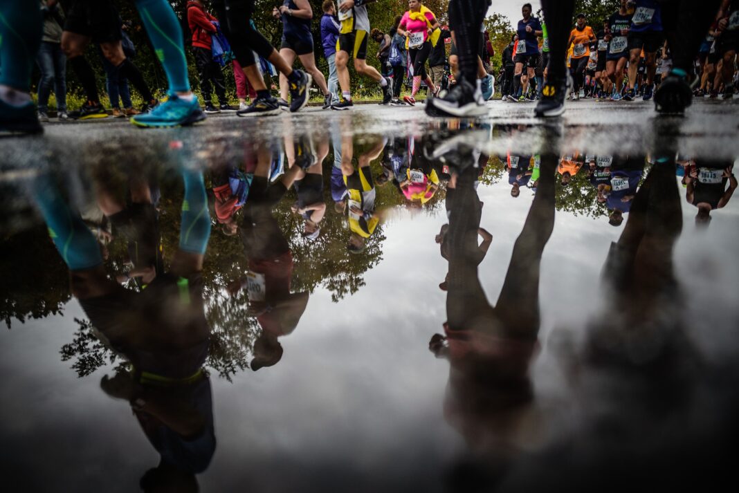 Marathon runners in winter, mid-race, focusing on their stride and determination.