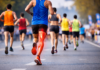 Why Your Legs Lock at 25K (And How to Fix It) Runner racing marathon with hamstring strain recovery focus